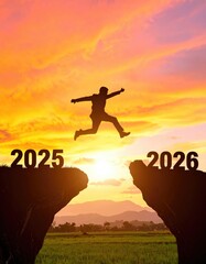 man Shiluete jump on cliff at sunset between 2025 and 2026 new year cocnept