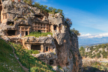 Happy family visiting ancient Greek city Tlos in Lycia located on Lycian way  Famous historical and archeological site. Popular place for family travel on summer vacation. Fethiye, Mugla, Turkey