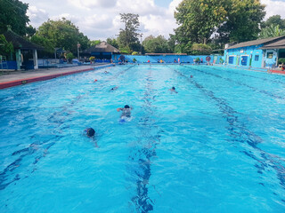 Children learn to swim, diving underwater with fun in the pool to stay fit. Healthy lifestyle