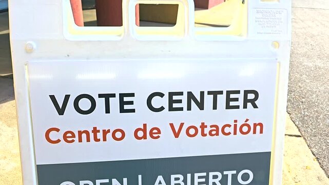 A bilingual sign &ldquo;Vote Center, Centro de Votaci&oacute;n &ndash; Open, Abierto&rdquo; with Spanish translation is shown outdoors, representing inclusivity, registration services, mail ballot support and in-person voting