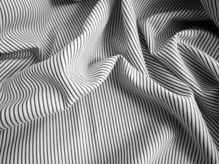 Crumpled black and white stripped fabric background. Wavy cloth texture