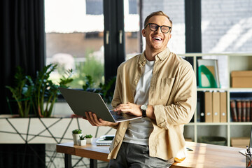 Confident young businessman working happily in a bright modern office space