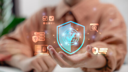 Businessman holding digital shield icon with cybersecurity, global data protection, privacy, secure access and online safety technology for business and finance security.