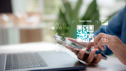 Hand holding smartphone scanning QR code for digital payment with secure online transaction. Concept of mobile banking, fintech, e-commerce, cashless society and financial technology.