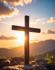 Wooden cross at sunset over mountains