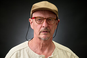 Closeup portrait of  senior with a brown Cap