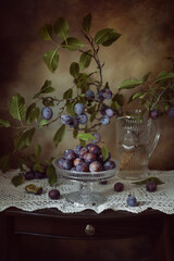 Still life. A photograph of ripe plums on a table.