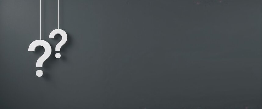 Frequently asked questions concept with two hanging white question mark symbols on a wide panoramic gray banner with copy space for text