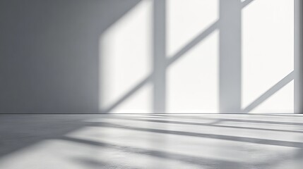 Obraz premium a refined, neutral studio background with a smooth grey-white wall, illuminated by soft sunlight filtering through an unseen window the gentle shadows create a dynamic interplay of light, forming