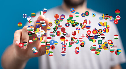 Person interacting with a digital display of world flags, symbolizing global connection and communication.