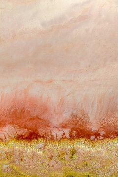Abstract aerial view of mineral deposits and textures at the edge of a salt lake