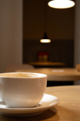 coffee in a white cup on a table in a cafe