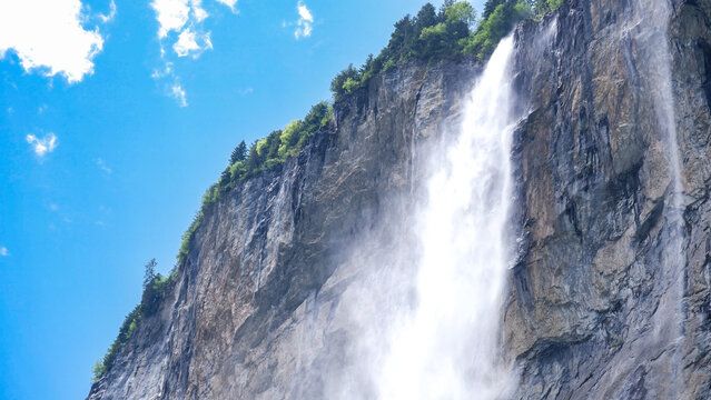 Staubbach Falls plunging from a tall cliff in Lauterbrunnen, Switzerland