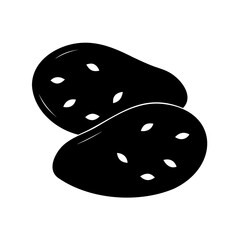 Two black potatoes with visible eyes lying on top of each other