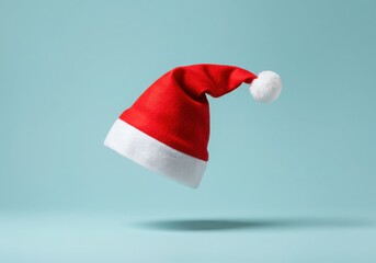 Red santa claus hat floating against a light blue background