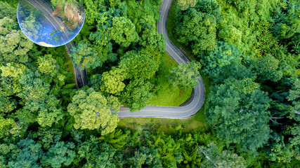 Aerial top view road in forest with car motion blur. Winding road through the forest. Car drive on...
