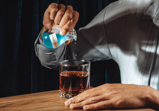 Irony of abuse with male hand pouring female tears into whiskey at bar