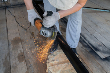 Man is using a power tool to cut a piece of wood