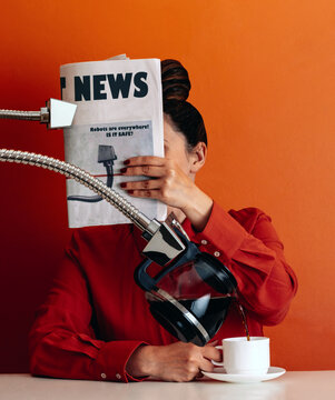 Futuristic robot hand pouring coffee for woman reading newspaper