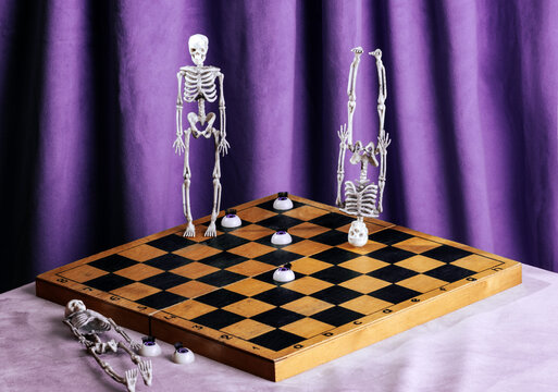 Surreal chessboard with skeletons and eyes on purple curtain backdrop