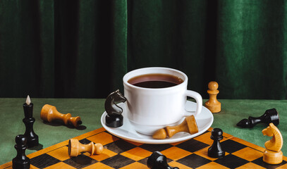 Chessboard and coffee cup still life with green velvet background