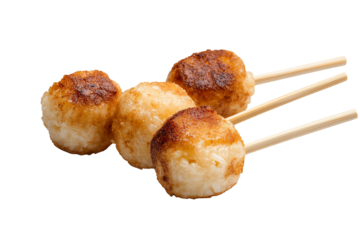 Delicious golden brown rice balls on wooden sticks, ideal for snacks or appetizers, white isolated background.