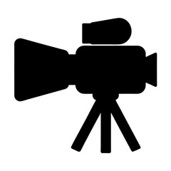 Silhouette of a vintage video camera on a tripod used for filming