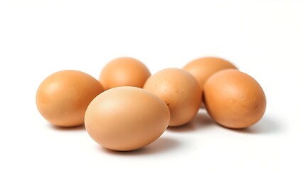 Brown eggs on a white surface, showcasing natural texture and subtle shadows in a minimalist composition.