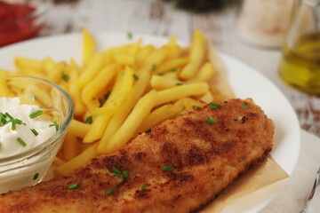Fish and chips served on the plate, traditional dish of Great Britain	