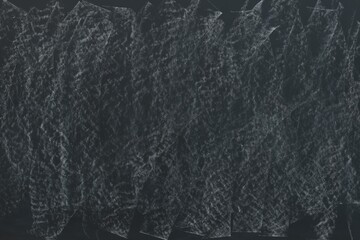 Dirty black chalkboard as background. School equipment