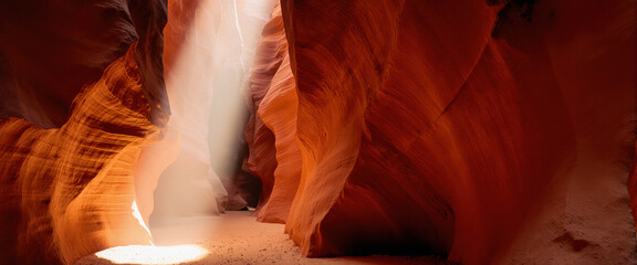 Golden hour in slot canyon illuminates red sandstone walls. The sandy path leads to bright exit with ethereal light quality.