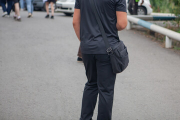 man with a bag and a backpack on the road