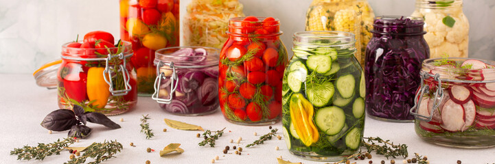Fresh vegetables like cabbage, tomatoes, cucumbers and radishes, onions, corn, peppers and cauliflower, fermenting naturally to boost health and preserve nutrients, banner