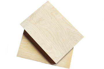 Wooden boards resting on a textured surface in a well-lit workspace during daytime