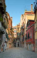 People walking along Calle dei Boteri in Venice