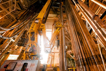 drilling equipment inside drilling rig on an offshore oil platform. hook, swivel and drill pipes...