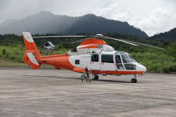 A helicopter on a small landing strip in the hills of Mizoram, India