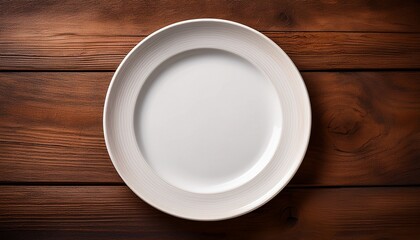top down perspective of a clean white ceramic plate resting on wood