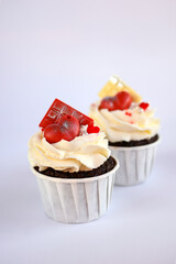 chocolate cupcakes with cream cheese frosting and festive decor. Valentine's day or birthday dessert. Beautiful festive food for a wedding or children's party.