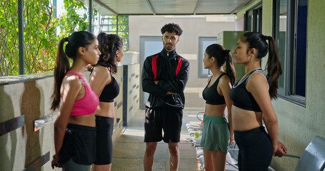 Indian young adult gen z sports woman lady group team fit coach man talk speak share plan ideas day...