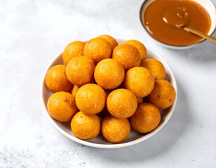 Golden, round treats piled high on a plate