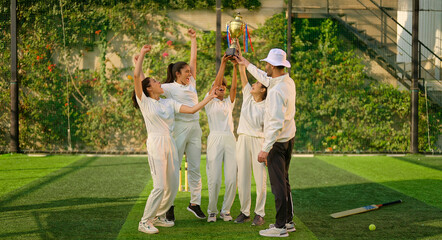 Indian asian young adult gen z sports woman lady group team standing with coach man win cricket match trophy do celebrate outdoor male trainer female player cheering having fun joy outside play ground