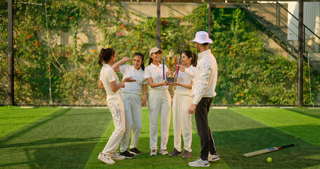 Indian asian young adult gen z sports woman lady group team standing with coach man win cricket match hold trophy do celebrate outdoor male trainer female player cheering have fun joy play ground
