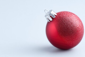 Shiny red Christmas ornament with textured surface, elegant holi