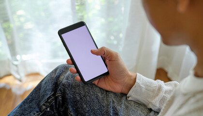 Man holding a phone with a blank screen while relaxing