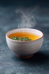 Warm herbal tea in textured bowl, steam rising, invites cozy amb