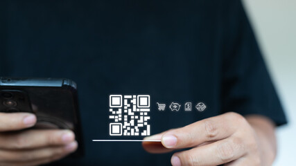 Hand holding smartphone with hologram QR code and digital finance icons. Concept of mobile banking, online payment, e-wallet, fintech transaction, secure money transfer, and a cashless society.