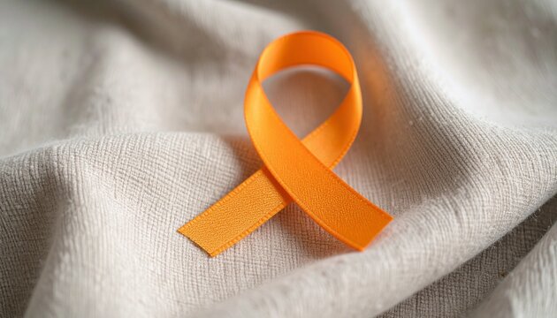 Orange Ribbon Symbolizing Awareness on Textured Fabric A Visual Representation