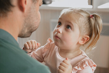 Happy Father Playing with Daughter. Three Years Baby Smiling, Laughing, Looking at Daddy. Man Showing Affection to Child. Candid Real Emotion. Beard Dad and Little Kid Girl. Authentic Family Lifestyle