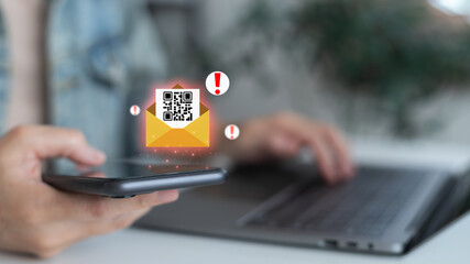 Close-up hand holding a smartphone with a hologram phishing email and QR code scam alert. Concept of cybersecurity, online fraud, phishing attack, data protection, spam risk, and IT security.